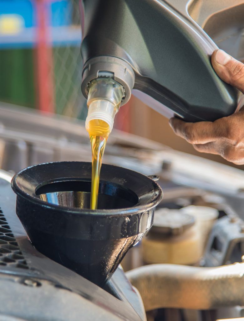 Engine being poured into a vehicle - Car Servicing Market Drayton